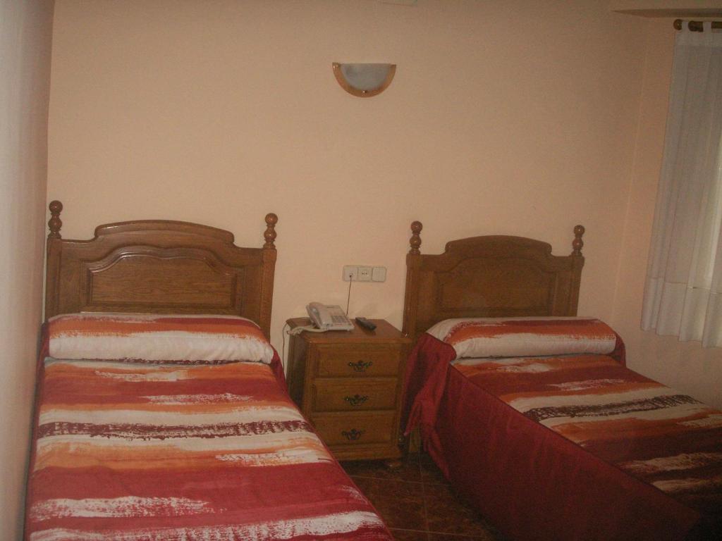A bed or beds in a room at Hostal La Nava