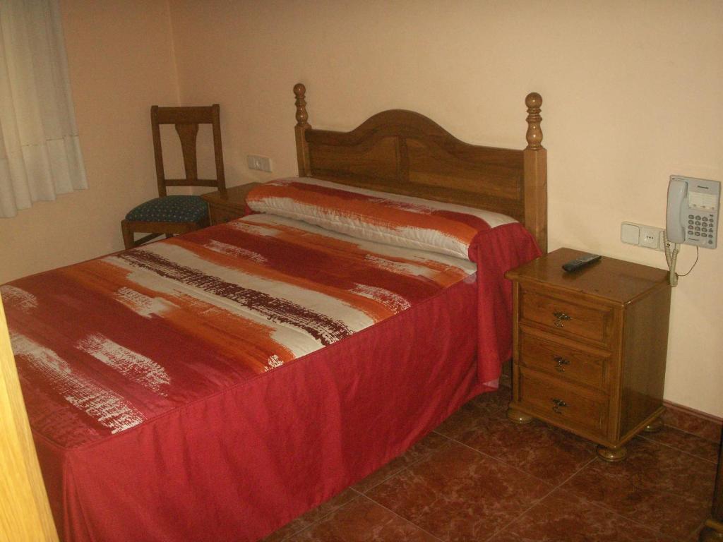 A bed or beds in a room at Hostal La Nava