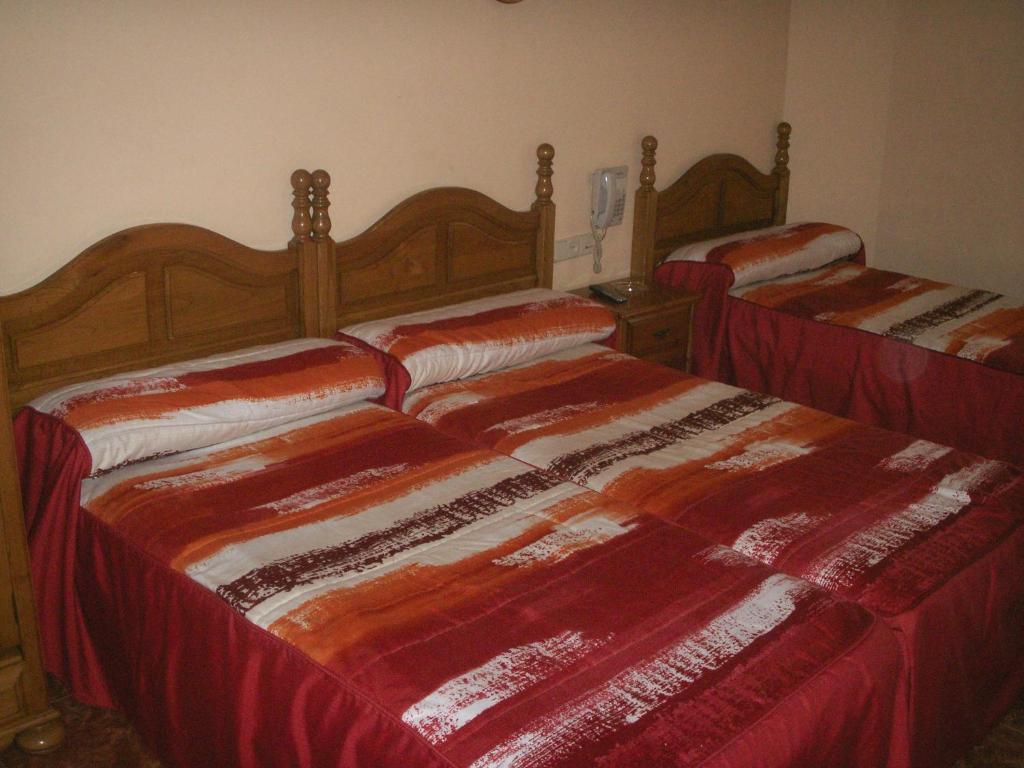 A bed or beds in a room at Hostal La Nava