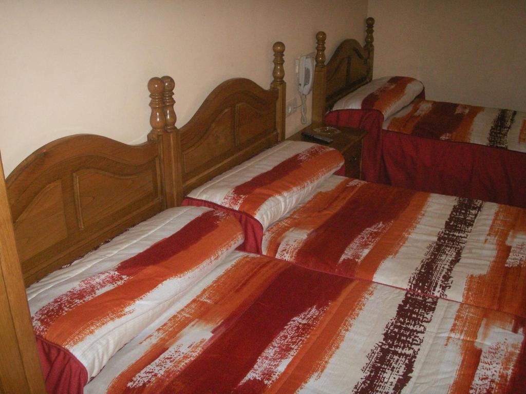 A bed or beds in a room at Hostal La Nava
