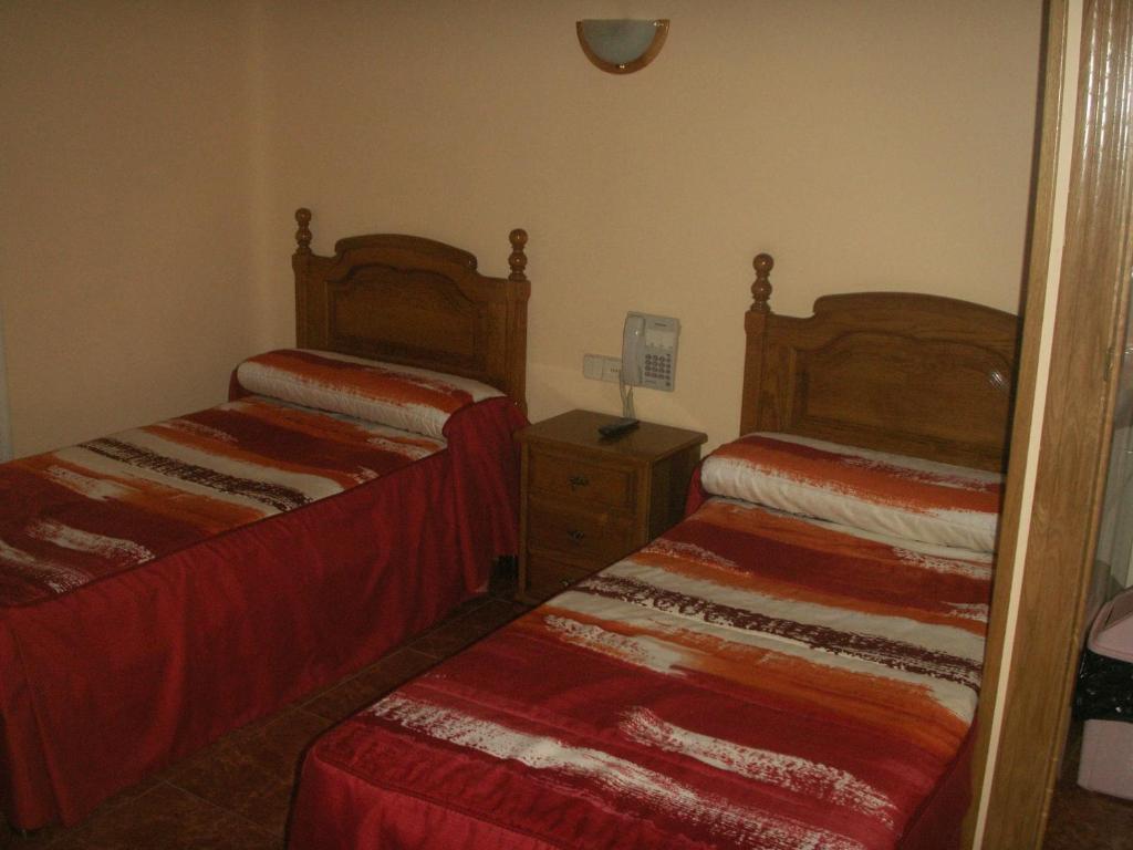 A bed or beds in a room at Hostal La Nava