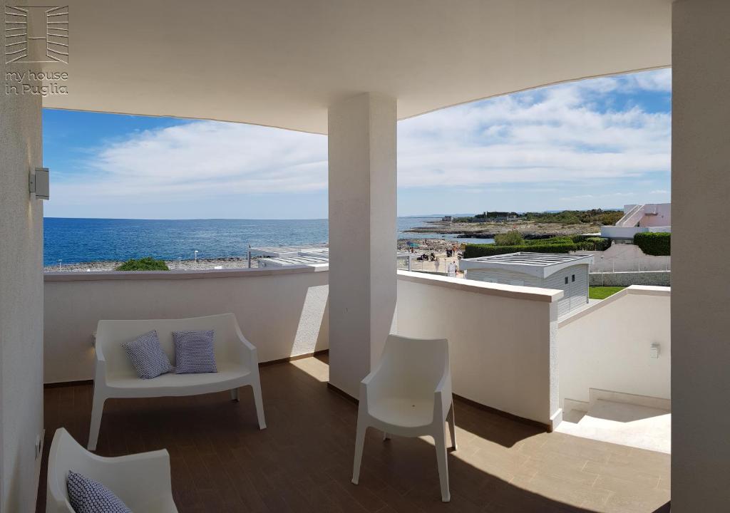 a balcony with chairs and a view of the ocean at Case Vacanza Marzano in Monopoli
