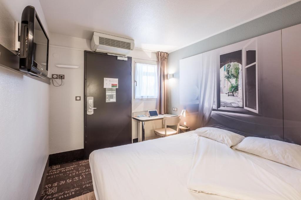 Postel nebo postele na pokoji v ubytování B&B HOTEL Valence Nord