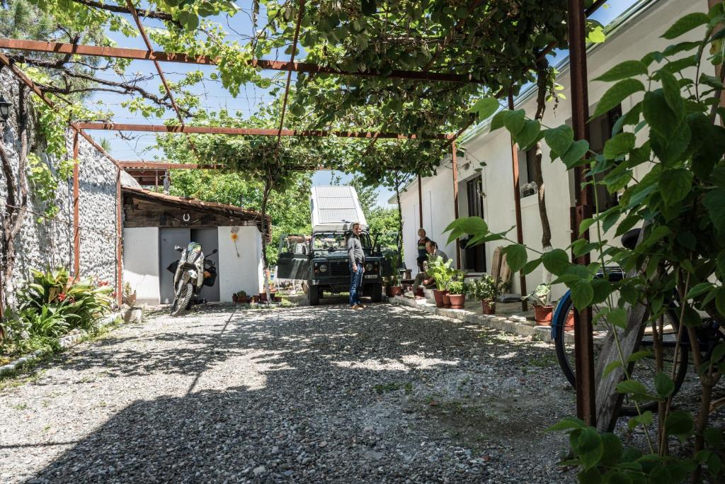 a man standing in the driveway of a house at Eco Garten Guest House in Shkodër