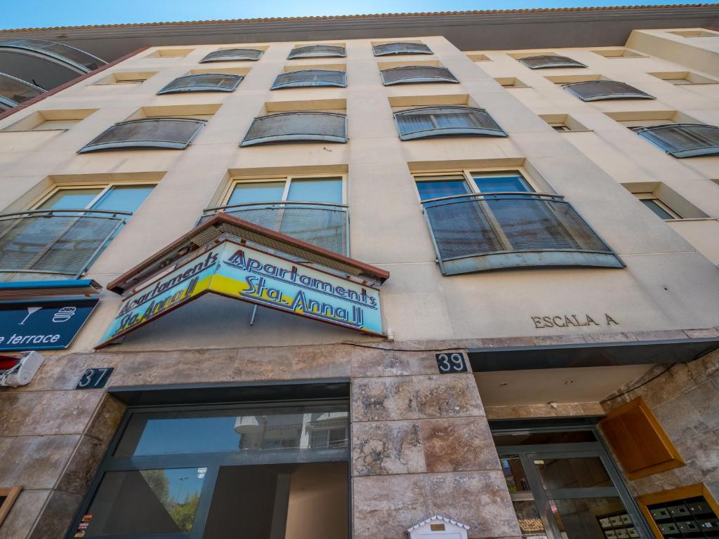 a building with a sign on the side of it at Apartaments AR Easy Santa Anna II in Lloret de Mar