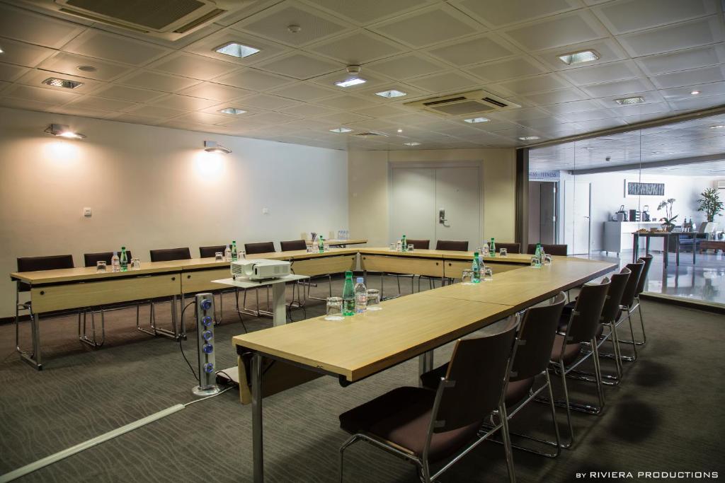 a conference room with tables and chairs in a room at Hotel Cannes Montfleury in Cannes