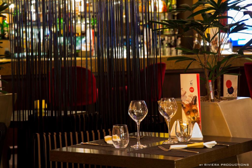 a table with wine glasses on top of it at Hotel Cannes Montfleury in Cannes