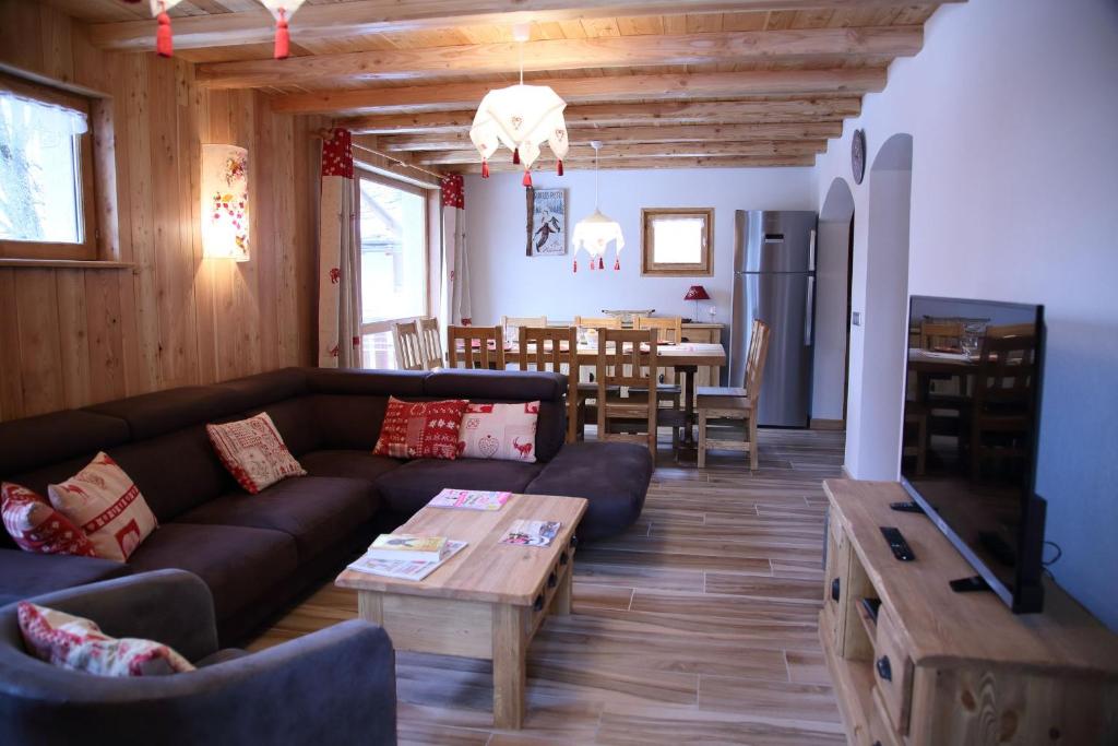 a living room with a couch and a table at A La Pastourelle in Bonneval-sur-Arc