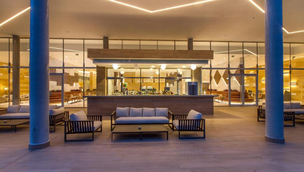 a lobby with couches and a bar in a building at ESTIMAR Calpe Suitopia in Calpe