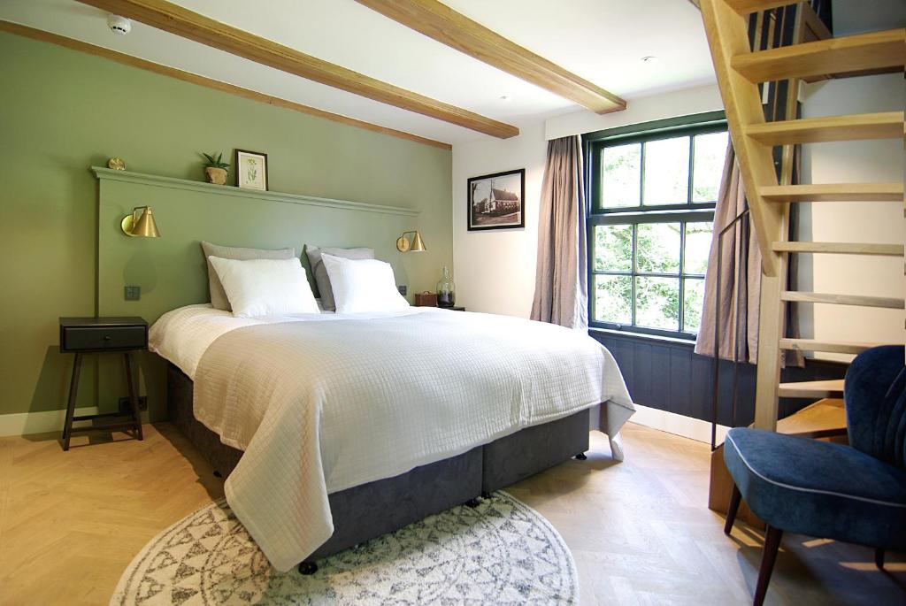 
a bedroom with a large bed and a large window at Authentic Farmhouse - De Vergulden Eenhoorn in Amsterdam
