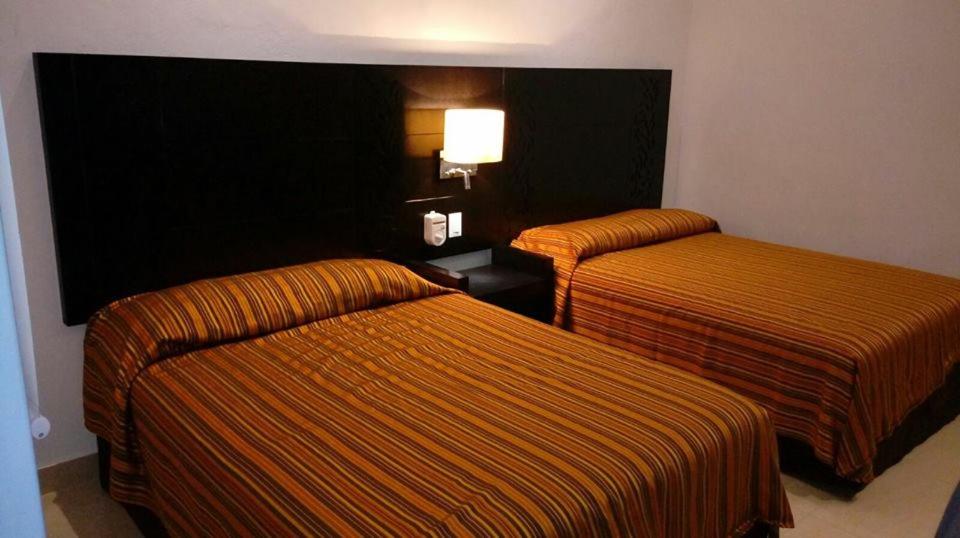 Postel nebo postele na pokoji v ubytování Aparthotel Siete 32