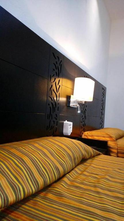 Postel nebo postele na pokoji v ubytování Aparthotel Siete 32