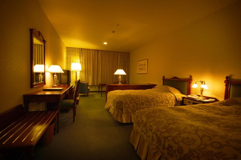 Postel nebo postele na pokoji v ubytování Sky Park Hotel