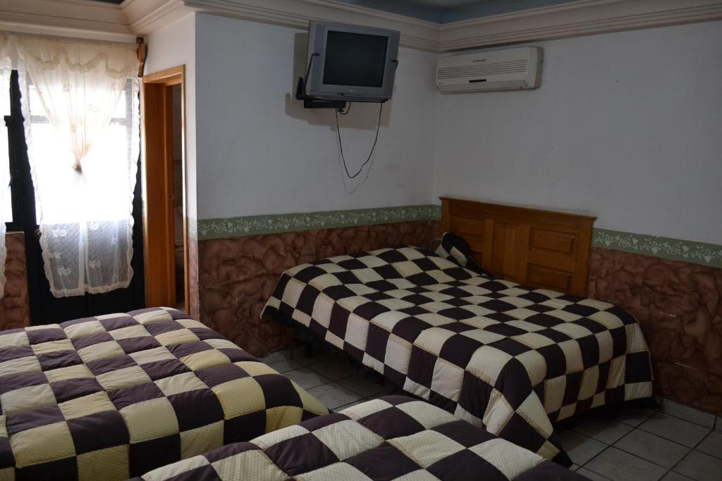 Postel nebo postele na pokoji v ubytování Hotel Senorial