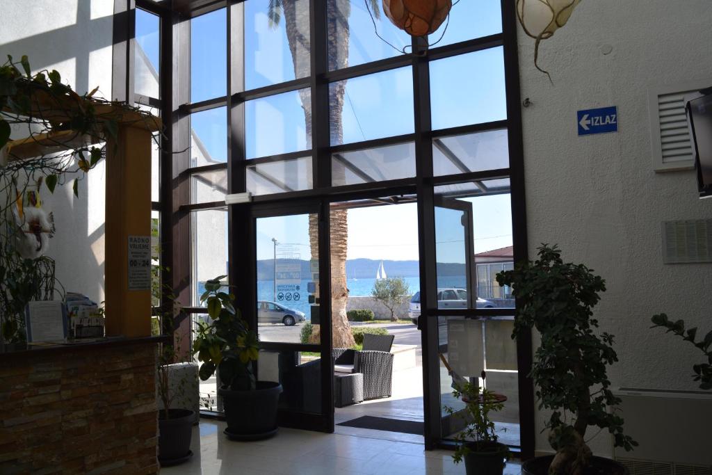 an entrance to a building with a large glass door at Hotel Ballet School in Kaštela
