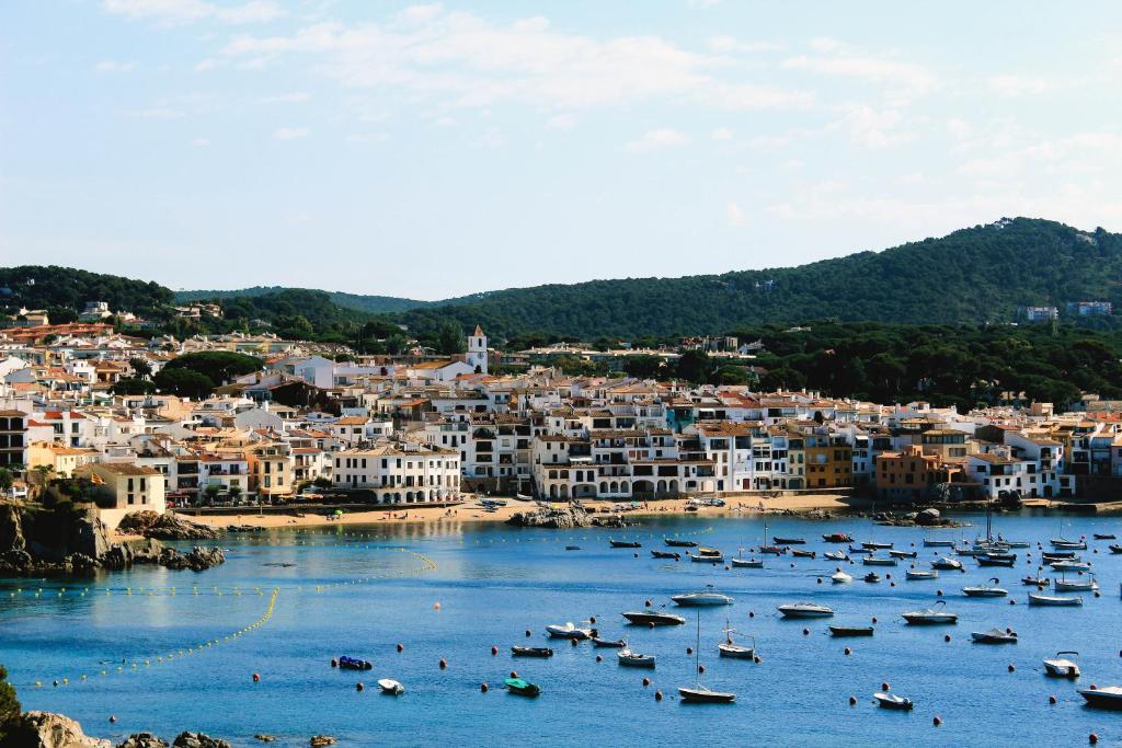 a group of boats in a body of water with buildings at Hotel Port-Bo in Calella de Palafrugell