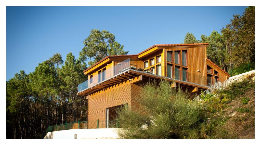 a wooden house on top of a hill at Eco House Tavilo in Outes