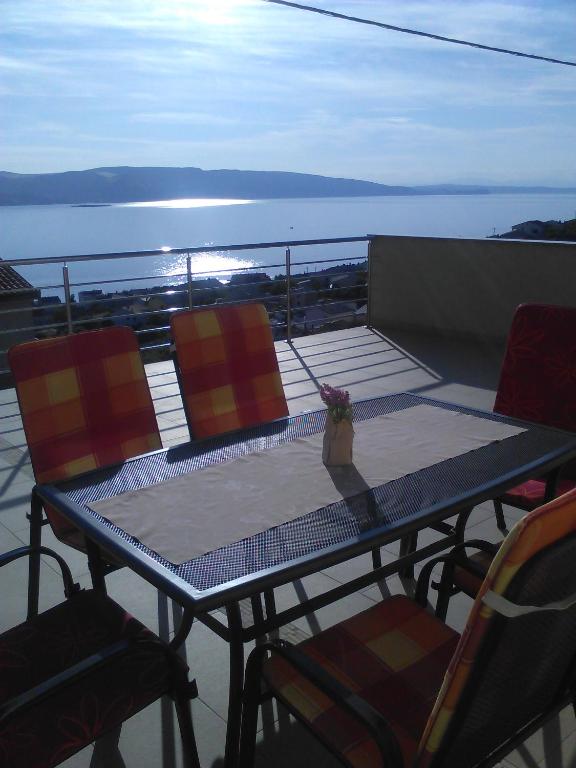 a table and chairs on the deck of a boat at H&T in Senj