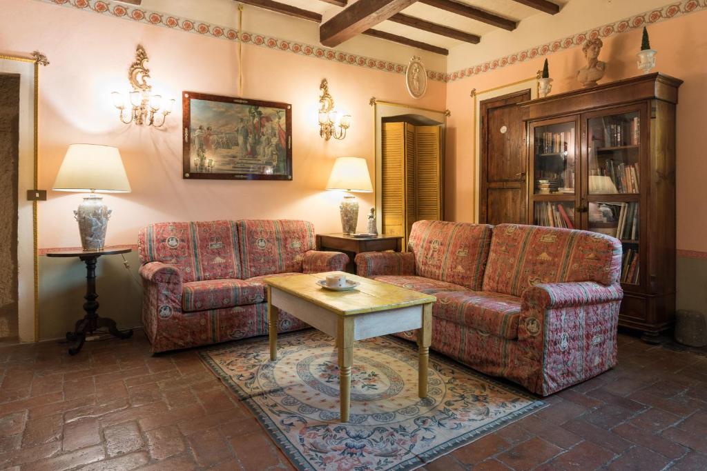 a living room with two couches and a table at Villa Lysis in Lastra a Signa