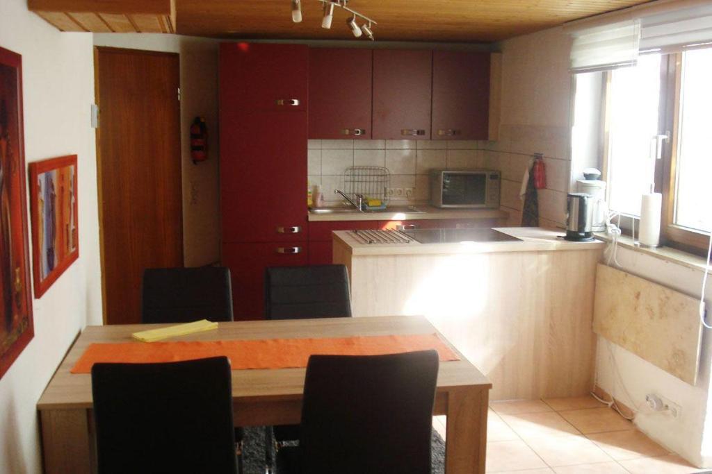 eine Küche mit einem Tisch und Stühlen im Zimmer in der Unterkunft 2 Zimmer-Appartement Seerose in Pliezhausen