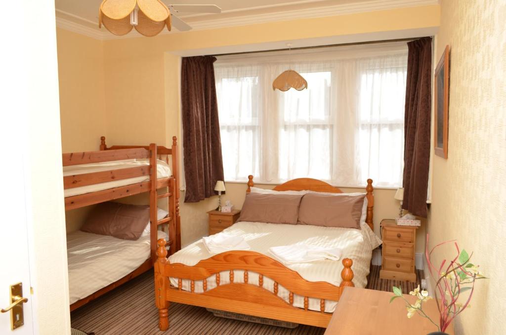 een slaapkamer met 2 stapelbedden en een raam bij Chandos Premier Folkestone (Channel Tunnel) Hotel in Folkestone