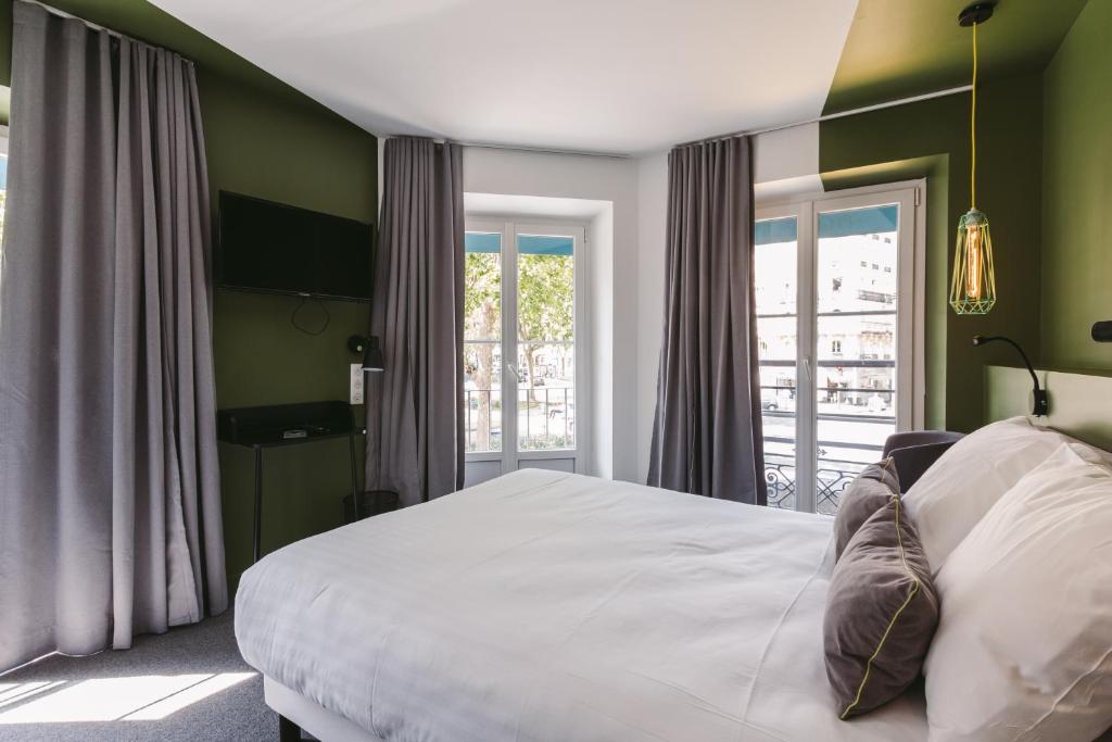 Postel nebo postele na pokoji v ubytování Le Petit Cosy Hôtel