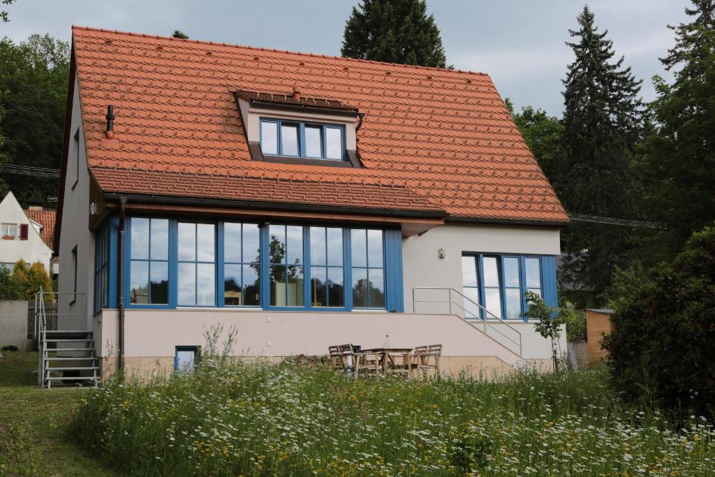 une maison avec un toit orange et une table dans l'établissement Rekreační vilka Zlenice, à Zlenice 