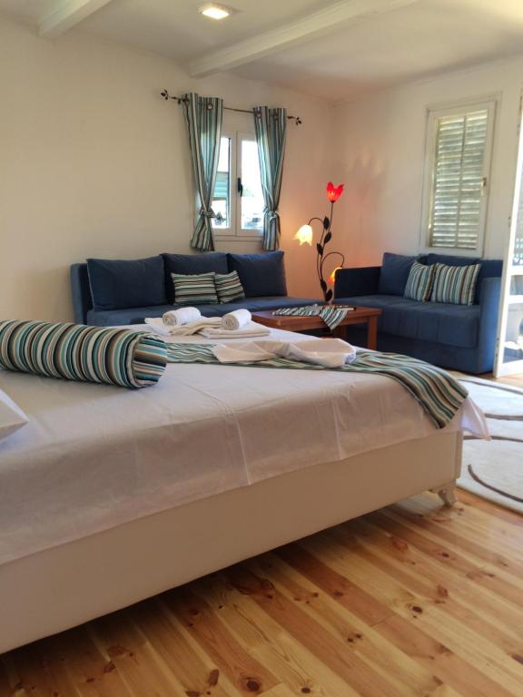a bedroom with a large bed and a blue couch at Apartment Soreja in Ulcinj