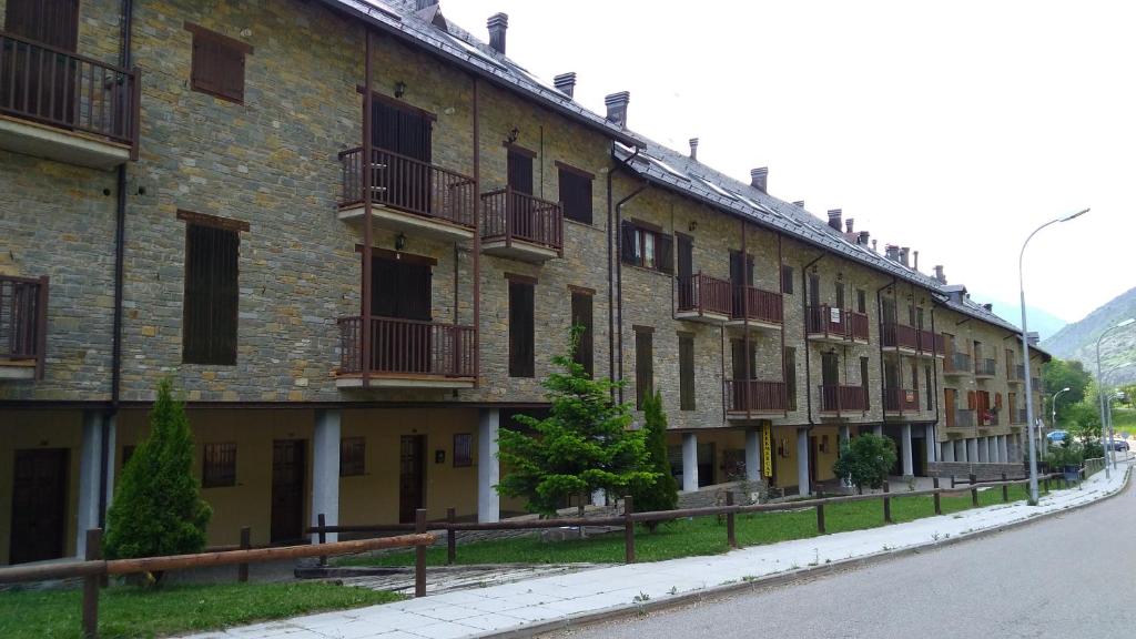 a large brick building with balconies on a street at Apartamento Erta in Pla de l'Ermita