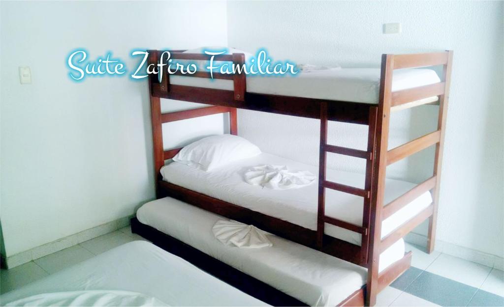 Postel nebo postele na pokoji v ubytování Suite Sumapaz Hotel