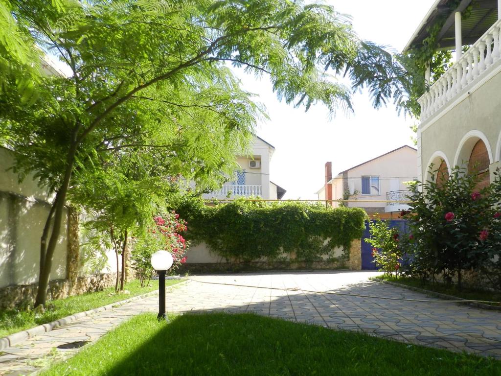 a yard with a walkway in front of a house at Dom on the seaside in Zatoka
