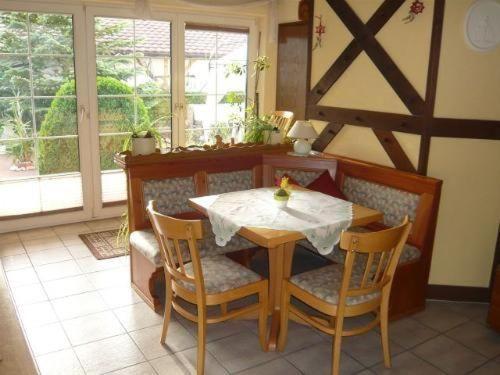 a table and chairs in a kitchen with a table and a window at Ferienwohnungen-Roder-Ferienwohnung-I in Freiburg im Breisgau