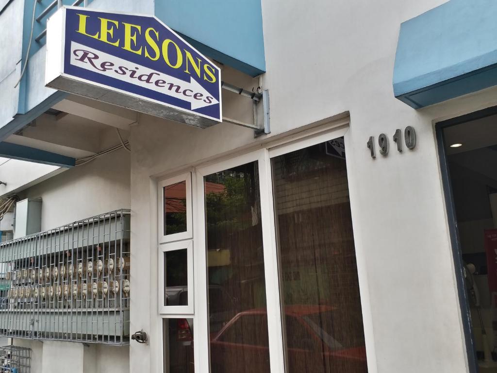 a sign for a restaurant on the side of a building at Leesons Residences in Manila