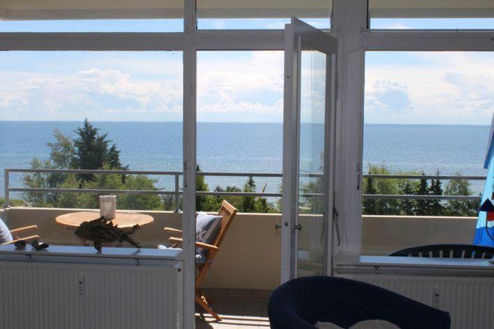 a room with a table and a view of the ocean at Ferienwohnung-Meeresblick in Großenbrode