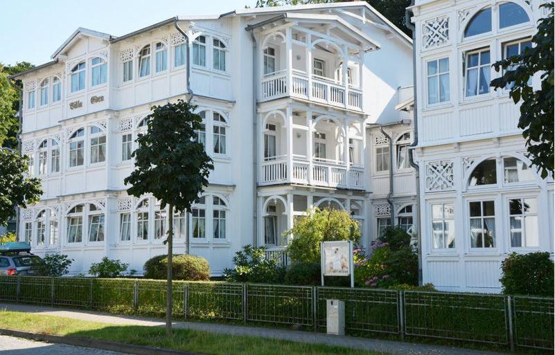 a large white building with a tree in front of it at Villa Eden Binz Typ 6 / Apartment 1 in Binz