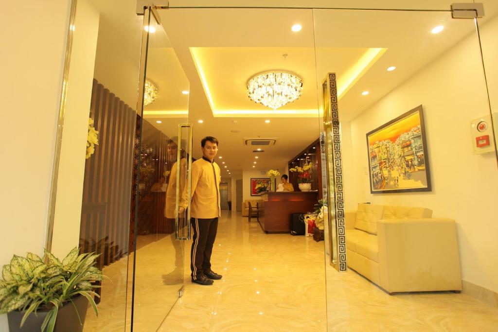 a man standing in a hallway of a house at Hanoi Pomihoa Hotel in Hanoi