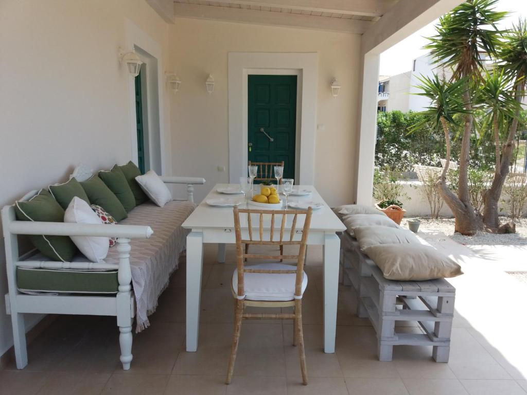 a room with a couch and a table and chairs at Villa Kedros in Kalamaki Heraklion