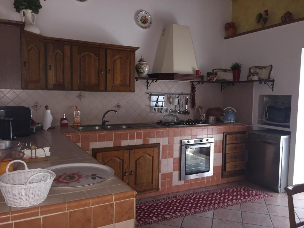 a kitchen with a sink and a stove top oven at Casale Del Borgo in Hermada