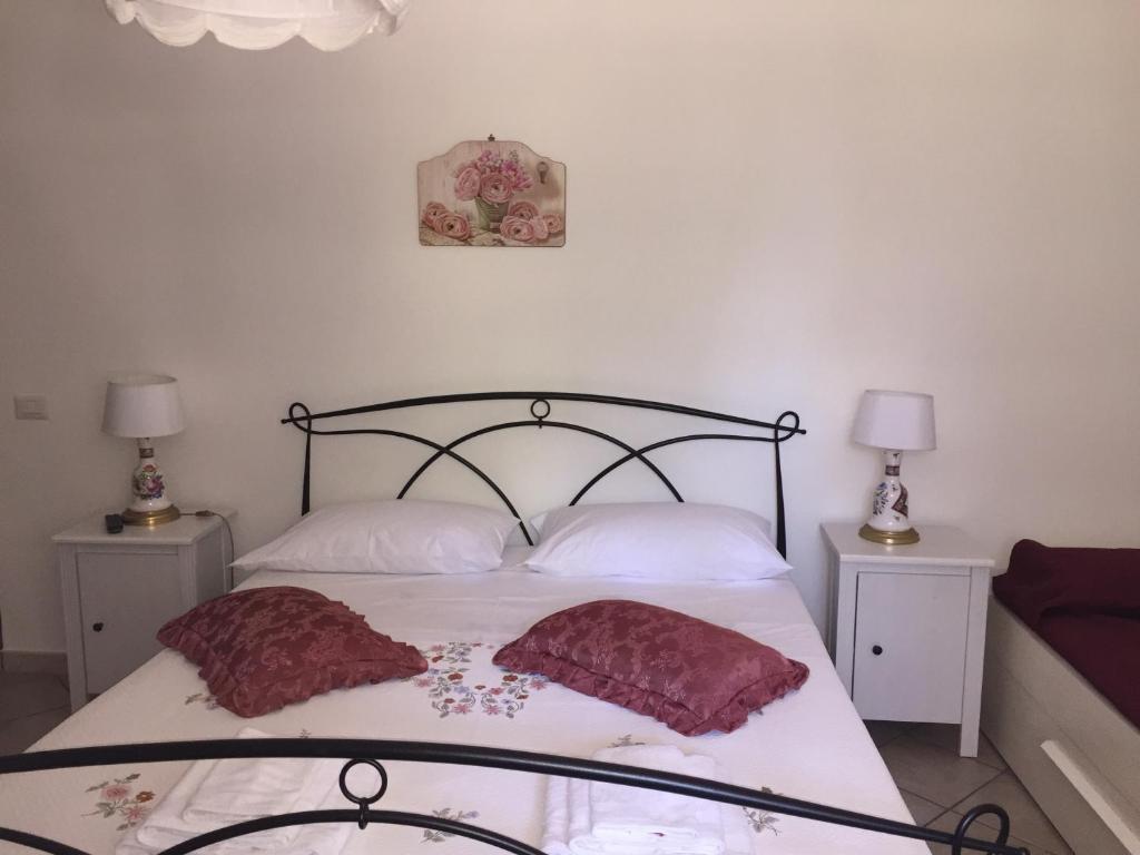 a bedroom with a bed with two pillows on it at Casale Del Borgo in Hermada
