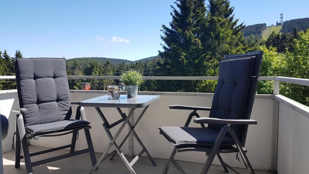 2 Stühle und ein Tisch auf dem Balkon in der Unterkunft Ferienwohnung Singer Am Erlebnisbocksberg in Goslar