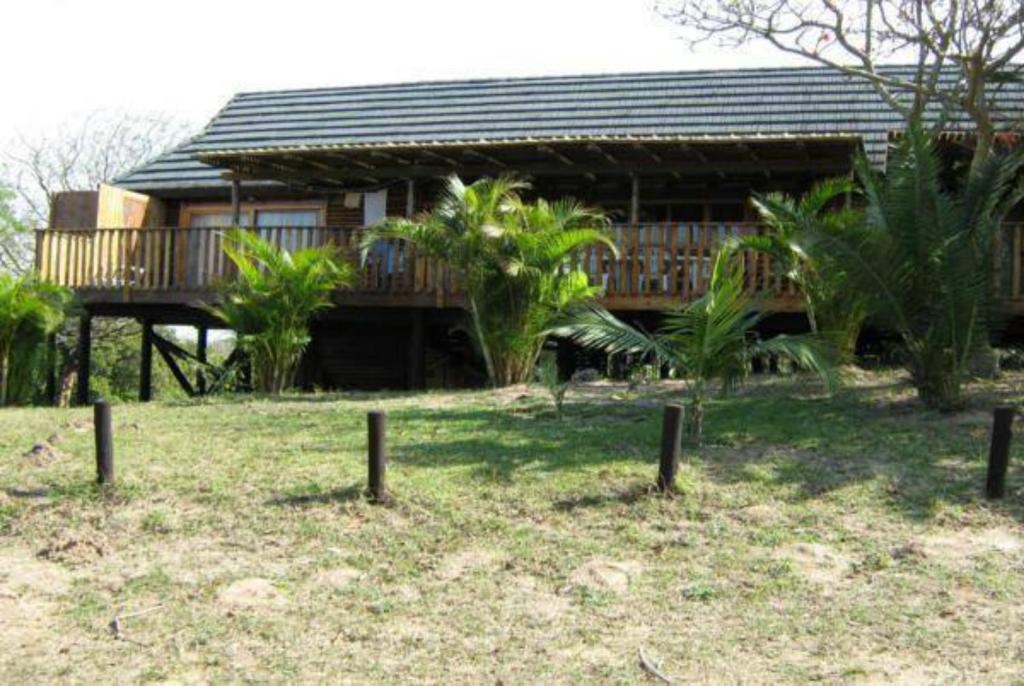 a large house with a deck on top of it at Sodwanabay Lodge House 58 in Sodwana Bay