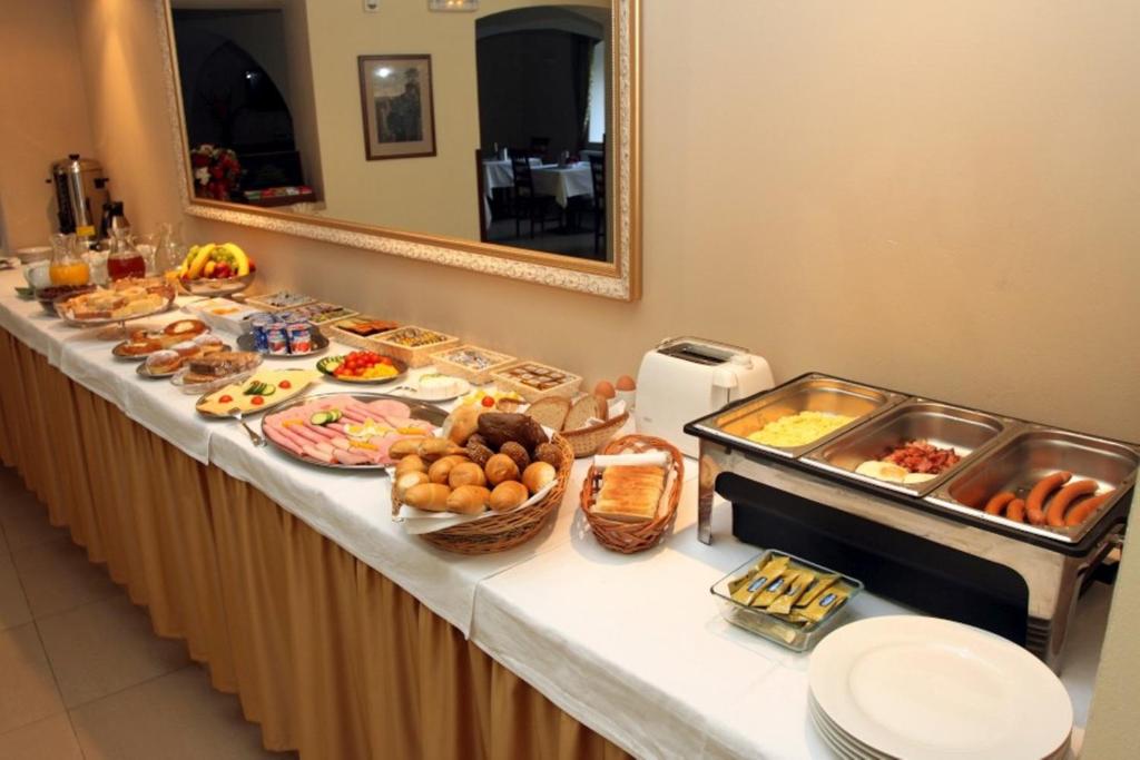 a buffet line with many different types of food at Hotel U Krále in Jičín