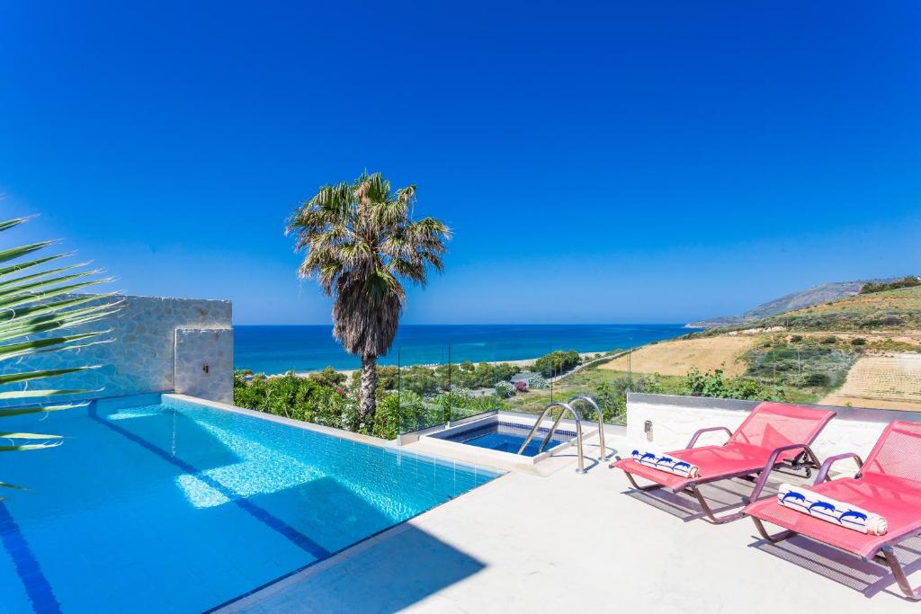 a villa with a swimming pool and a view at Sea View Villas in Episkopí- Rethimno