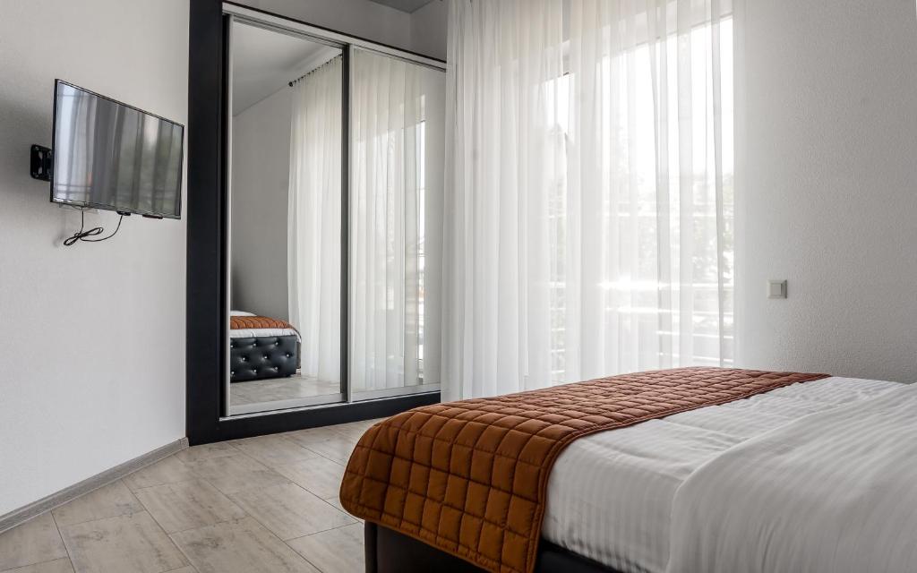 Postel nebo postele na pokoji v ubytování Hotel Sorrento