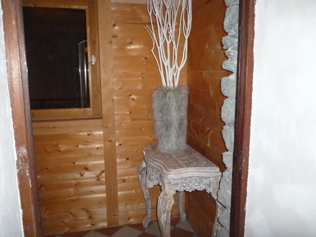 a vase sitting on a stool in a room at Le Mazot in Villaroger