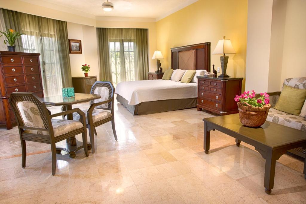 um quarto com uma cama, uma mesa e um sofá em Hotel Los Itzaes by 5th av em Playa del Carmen