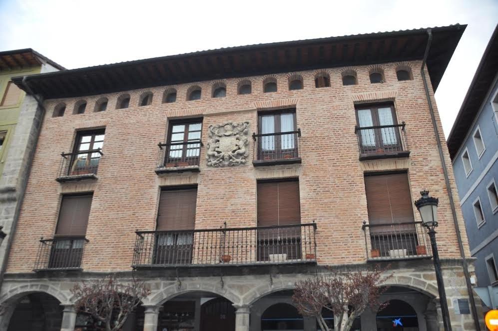 a brick building with a clock on the side of it at Mimenza in Orduña
