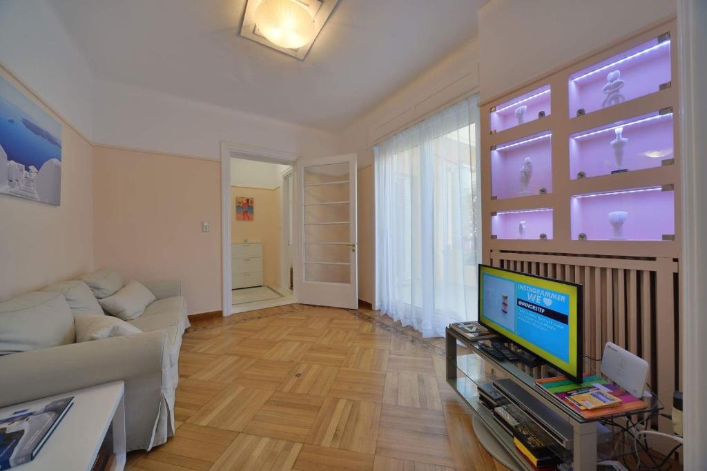 A television and/or entertainment centre at Oasis veranda under columns.Kolonaki embassy area.