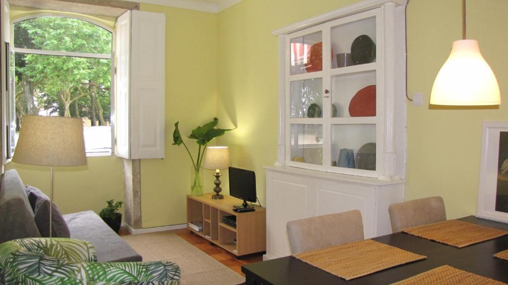 a living room with a dining table and a window at Foz Gardens in Porto