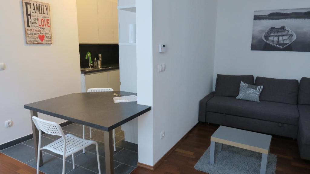 a living room with a table and a couch at 2 Zimmer Wohnung in Vienna